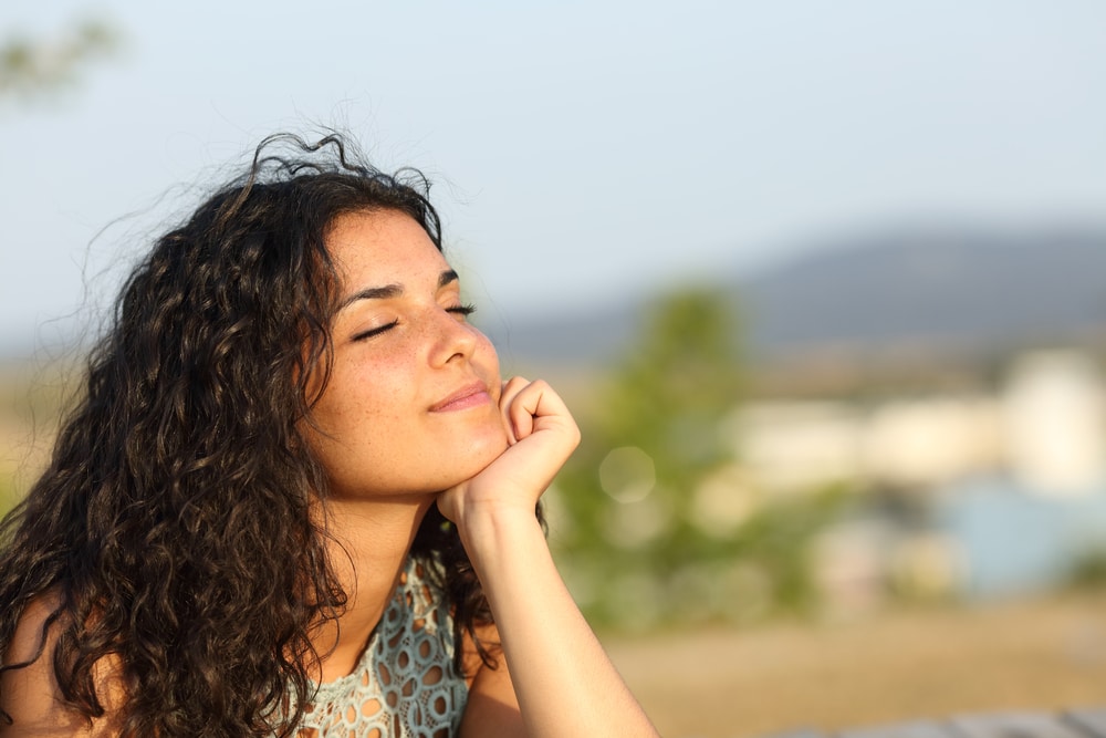 Woman,Relaxing,And,Enjoying,The,Sun,In,A,Warmth,Park